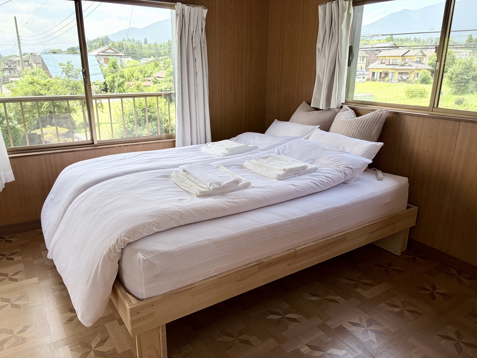 A bright queen bedroom with mountain views at Haku
